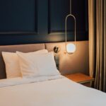 변화하는 여성 건강관리, 작은 습관이 만드는 큰 차이 a bed with white sheets and pillows in a room